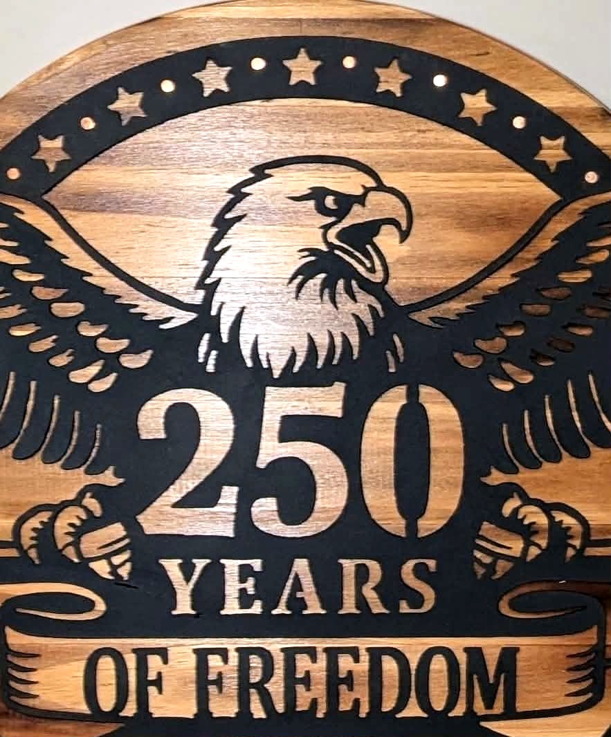 Close-up of the cut steel eagle, 250 Years of Freedom banner and copper nail accents