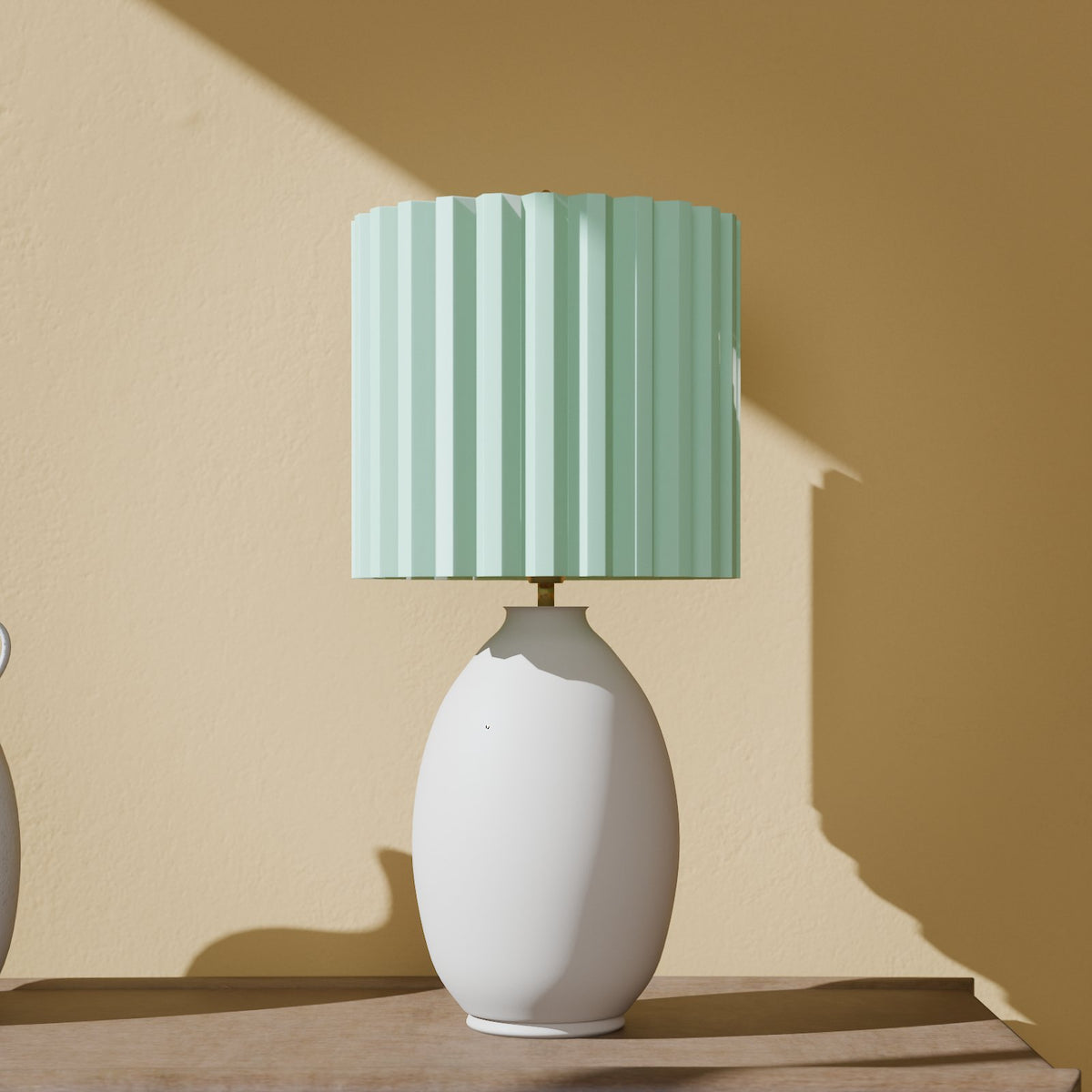 Glow-in-the-dark pleated lamp shade in Glow Green on a table lamp