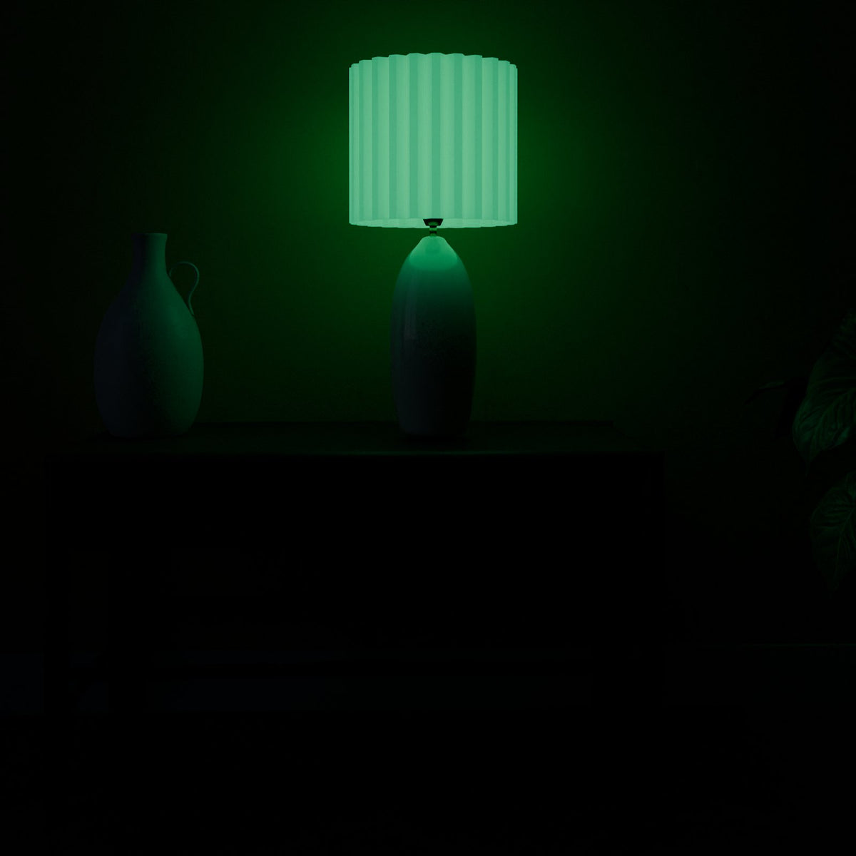 Glow Green lamp shade glowing in a dark room with the lamp off
